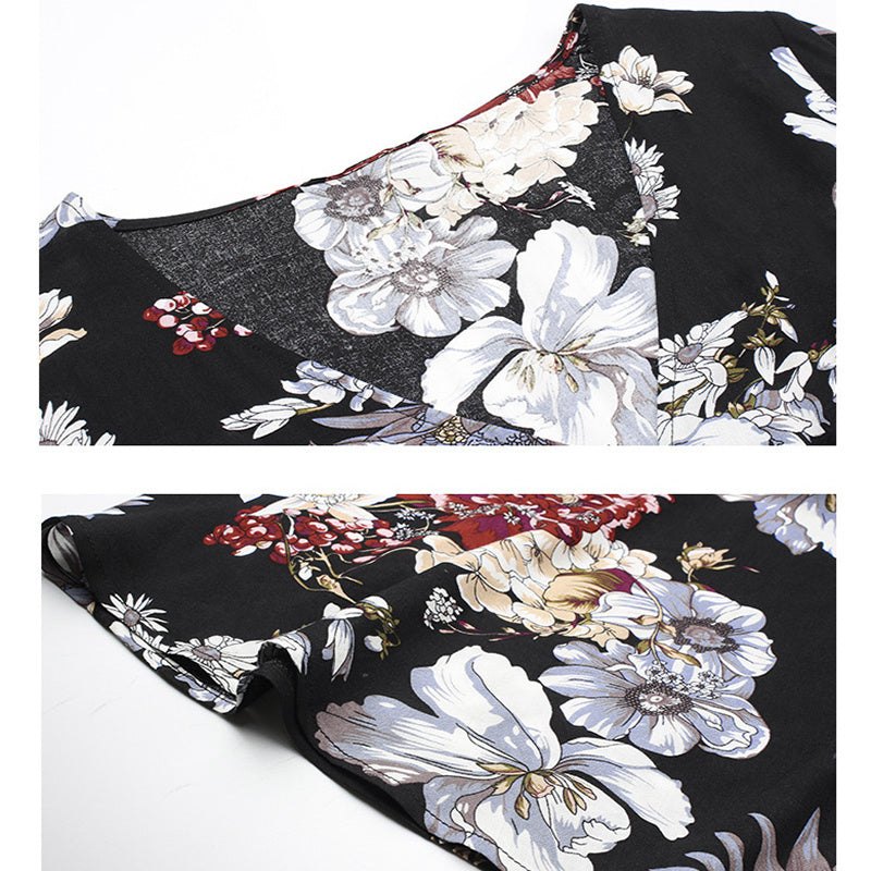 Détail d'une robe d'été fleurie noire avec motifs floraux blancs et touches de rouge, tissu fluide et coupe élégante.