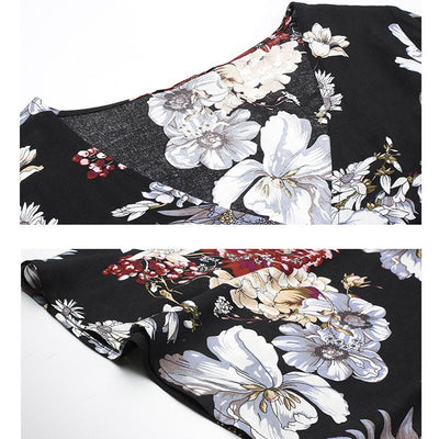 Détail d'une robe d'été fleurie noire avec motifs floraux blancs et touches de rouge, tissu fluide et coupe élégante.